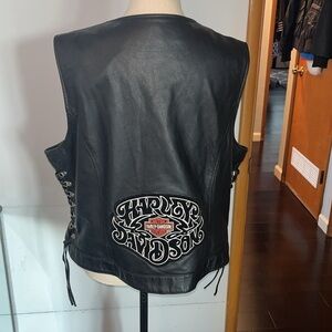 Harley Davidson Woman’s Black Leather vest w/Leather ties on side.  Womans XL